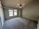 Spacious carpeted bedroom with ceiling fan and large windows at 5812 S Jericho Way, Centennial, CO 80015