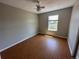 Simple bedroom featuring wood-look floors and a window at 5812 S Jericho Way, Centennial, CO 80015