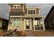 Two-story house with brown siding and stone accents at 2271 Serenidad St, Brighton, CO 80601