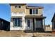 Two-story home with light brown siding and stone accents at 2271 Serenidad St, Brighton, CO 80601