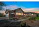 Brick and beige home with a large yard, a two-car garage, and a basketball hoop at 2203 S County Road 185, Byers, CO 80103