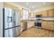 Modern kitchen featuring stainless steel appliances and wood cabinets at 2203 S County Road 185, Byers, CO 80103