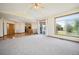 Large living room with hardwood and carpeted floors, and views of backyard at 2203 S County Road 185, Byers, CO 80103