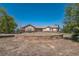 House exterior with a circular garden and stone wall at 2203 S County Road 185, Byers, CO 80103