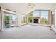 Spacious living room with vaulted ceiling, fireplace, and access to deck at 2203 S County Road 185, Byers, CO 80103