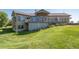 Two-story home with a large deck and a nicely landscaped yard at 2203 S County Road 185, Byers, CO 80103