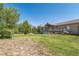 Spacious backyard offering ample green space and a playset at 2203 S County Road 185, Byers, CO 80103