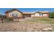 Ranch-style home with brick and siding exterior, a large yard, and a split 3-car garage at 2203 S County Road 185, Byers, CO 80103