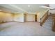 Finished basement with neutral carpeting and stairs at 2203 S County Road 185, Byers, CO 80103