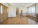 Bright entryway with hardwood floors, staircase, and view of kitchen at 2203 S County Road 185, Byers, CO 80103