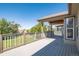 Relaxing deck overlooking a grassy backyard with a scenic view at 2203 S County Road 185, Byers, CO 80103