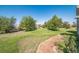 Landscaped backyard with a brick walkway and lush green grass at 2203 S County Road 185, Byers, CO 80103