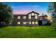 Two-story house with large windows, deck, and landscaped yard at dusk at 2203 S County Road 185, Byers, CO 80103