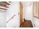 Modern stairwell with hardwood floors and wood railing at 35 S Ogden St, Denver, CO 80209