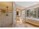 Spa-like bathroom with shower, bathtub, and large window at 17820 Pinto Way, Monument, CO 80132