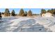 Snow-covered circular riding arena with metal railing at 17820 Pinto Way, Monument, CO 80132