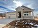 New construction home with stone accents, two-car garage, and covered porch at 24510 E 36Th Ave, Aurora, CO 80019