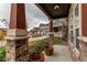 Inviting front porch with stone pillars and wooden planters, showcasing a charming neighborhood view at 10303 Pitkin Ct, Commerce City, CO 80022