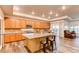 Spacious kitchen with granite island and light wood cabinets at 10303 Pitkin Ct, Commerce City, CO 80022