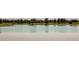 Serene community pond reflecting surrounding trees and homes at 10303 Pitkin Ct, Commerce City, CO 80022