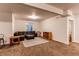 Finished basement Gathering room with a leather sectional sofa and large windows at 10303 Pitkin Ct, Commerce City, CO 80022