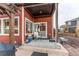 Covered patio with seating and sliding glass door at 10303 Pitkin Ct, Commerce City, CO 80022