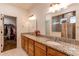 Double vanity bathroom with granite countertops and a walk-in shower at 10303 Pitkin Ct, Commerce City, CO 80022