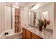 Bathroom with granite countertop, tub, and decorative shower curtain at 10303 Pitkin Ct, Commerce City, CO 80022
