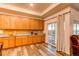 Kitchen with wood cabinets, granite countertops, and access to patio at 10303 Pitkin Ct, Commerce City, CO 80022