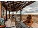 Backyard patio with pergola, seating, and water feature at 10303 Pitkin Ct, Commerce City, CO 80022