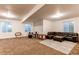 Finished basement recreation area with a leather sectional sofa and drum set at 10303 Pitkin Ct, Commerce City, CO 80022