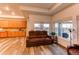 Spacious living room with large windows and a comfortable leather couch at 10303 Pitkin Ct, Commerce City, CO 80022