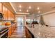 Kitchen with granite countertops, wood cabinets, and sliding door to patio at 10303 Pitkin Ct, Commerce City, CO 80022