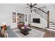 Bright living room features hardwood floors, a staircase, and views into the kitchen at 640 Pacific Ave, Fort Lupton, CO 80621