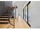 Modern hallway with light oak floors and sleek staircase at 4107 Bryant St, Denver, CO 80211