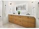 Modern bathroom with double vanity and a large mirror at 4107 Bryant St, Denver, CO 80211