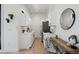Modern white kitchenette with breakfast bar and appliances at 4107 Bryant St, Denver, CO 80211