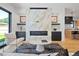 Open living space with a stunning marble fireplace and kitchen views at 4107 Bryant St, Denver, CO 80211