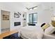 Bright bedroom with fireplace, large windows, and hardwood floors at 4107 Bryant St, Denver, CO 80211