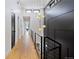 Long hallway with light wood floors and modern lighting at 4107 Bryant St, Denver, CO 80211