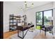 Bright home office features a large window, built-in shelving, and a wooden desk at 4107 Bryant St, Denver, CO 80211