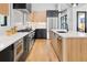 Modern kitchen with stainless steel appliances and two-toned cabinetry at 4107 Bryant St, Denver, CO 80211