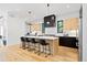 Modern kitchen with an island, stainless steel appliances, and light wood cabinets at 4107 Bryant St, Denver, CO 80211