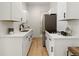 Modern galley kitchen with white shaker cabinets at 4107 Bryant St, Denver, CO 80211