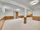 Open floor plan basement with neutral carpeting and wood paneling at 17 Dartmouth Cir, Longmont, CO 80503