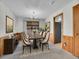 Formal dining room with a wood-paneled accent wall and a chandelier at 17 Dartmouth Cir, Longmont, CO 80503