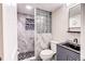 Modern bathroom with a glass block shower and stylish vanity at 6039 W Fair Dr, Littleton, CO 80123