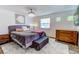 Spacious bedroom with king-size bed and wood dresser at 6039 W Fair Dr, Littleton, CO 80123