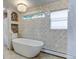 Bathroom with a freestanding tub and decorative tile at 6039 W Fair Dr, Littleton, CO 80123