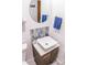 Small powder room featuring a floating vanity and hexagon tile at 6039 W Fair Dr, Littleton, CO 80123